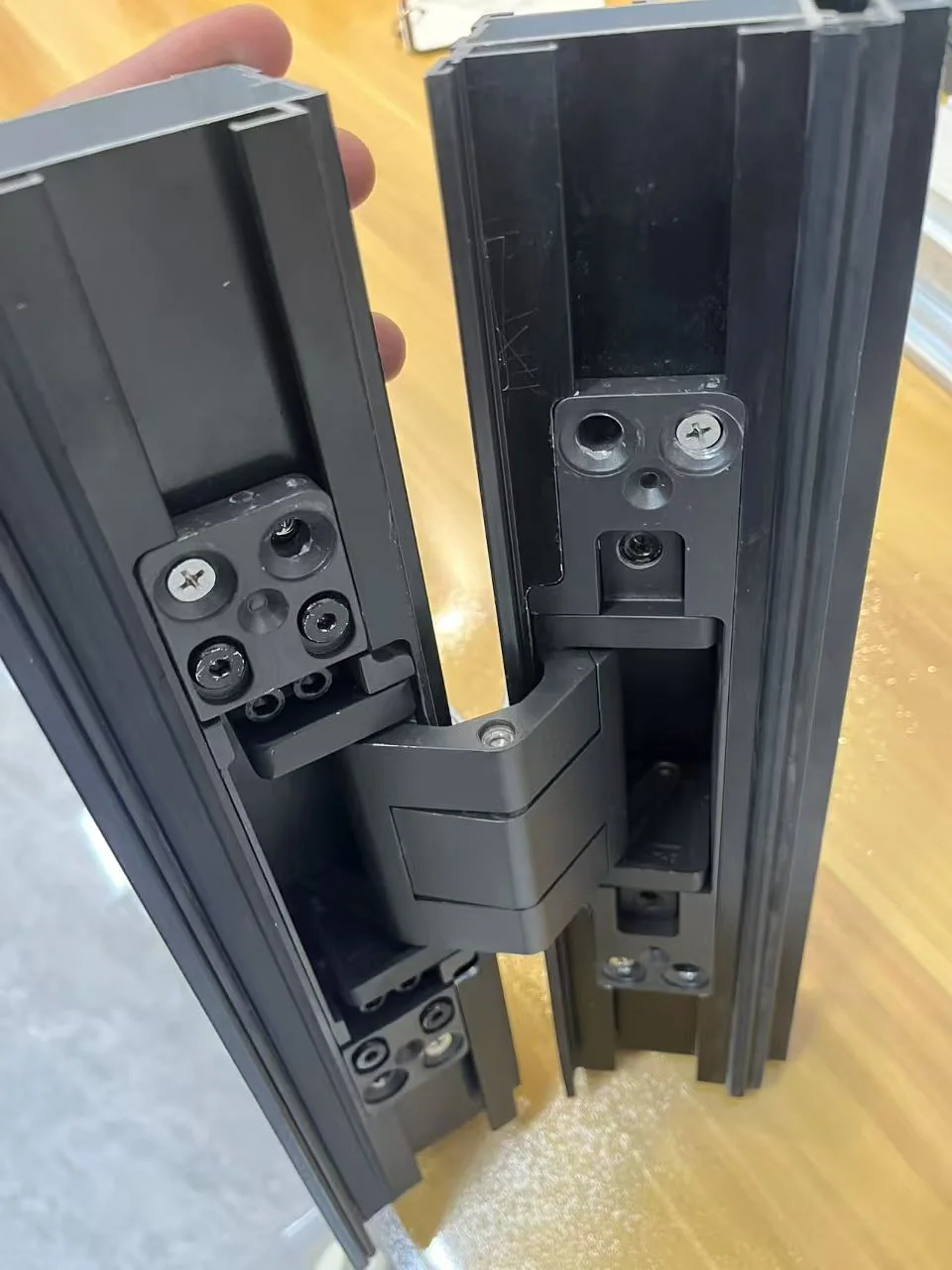 Heavy aluminum door hinge installed in a real door profile