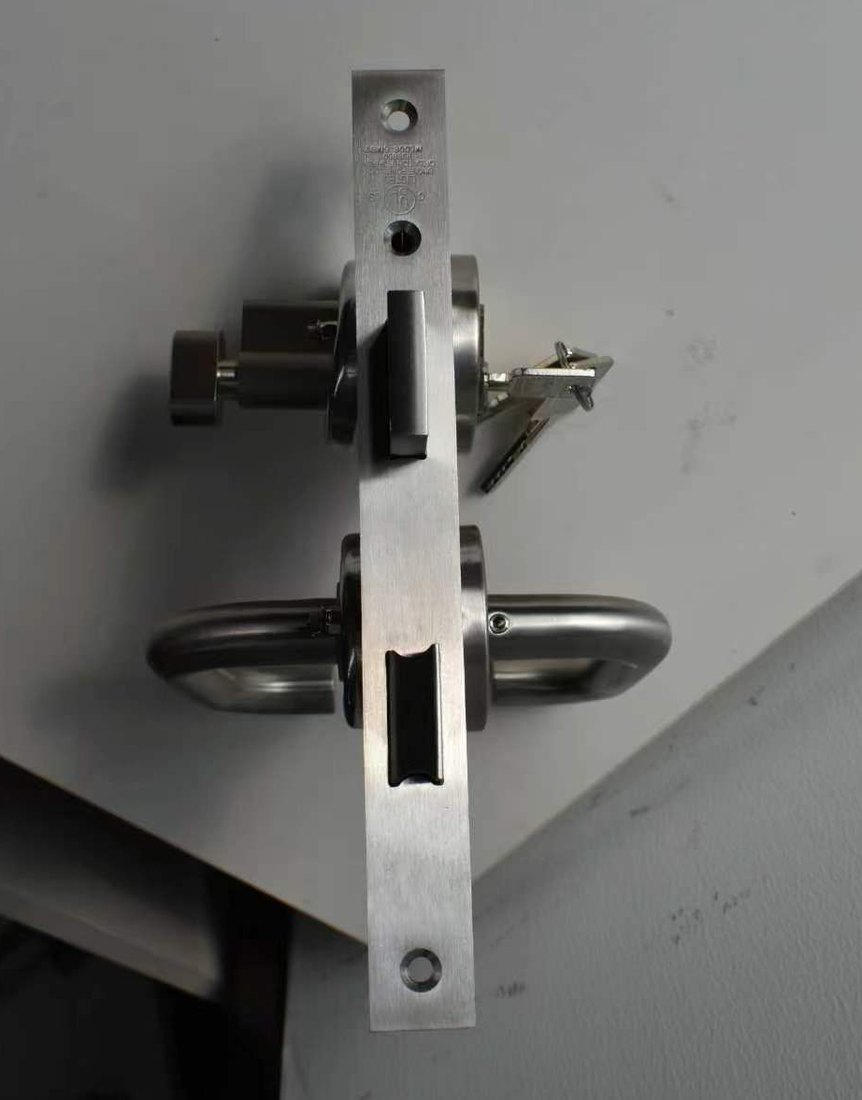 UL mark stamped on the faceplate of a listed fire door lockset